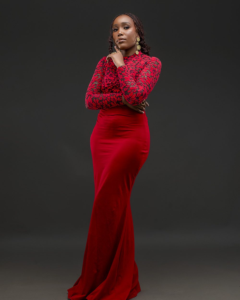 Model in a red lace and jersey column gown